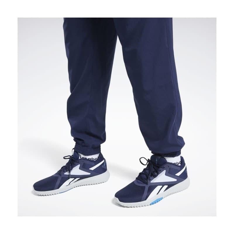 Reebok Mens' Training Essentials Woven Cuffed Pants- بنطلون ريبوك ترينيغ ايسنشيال ويفن للرجال لون أزرق